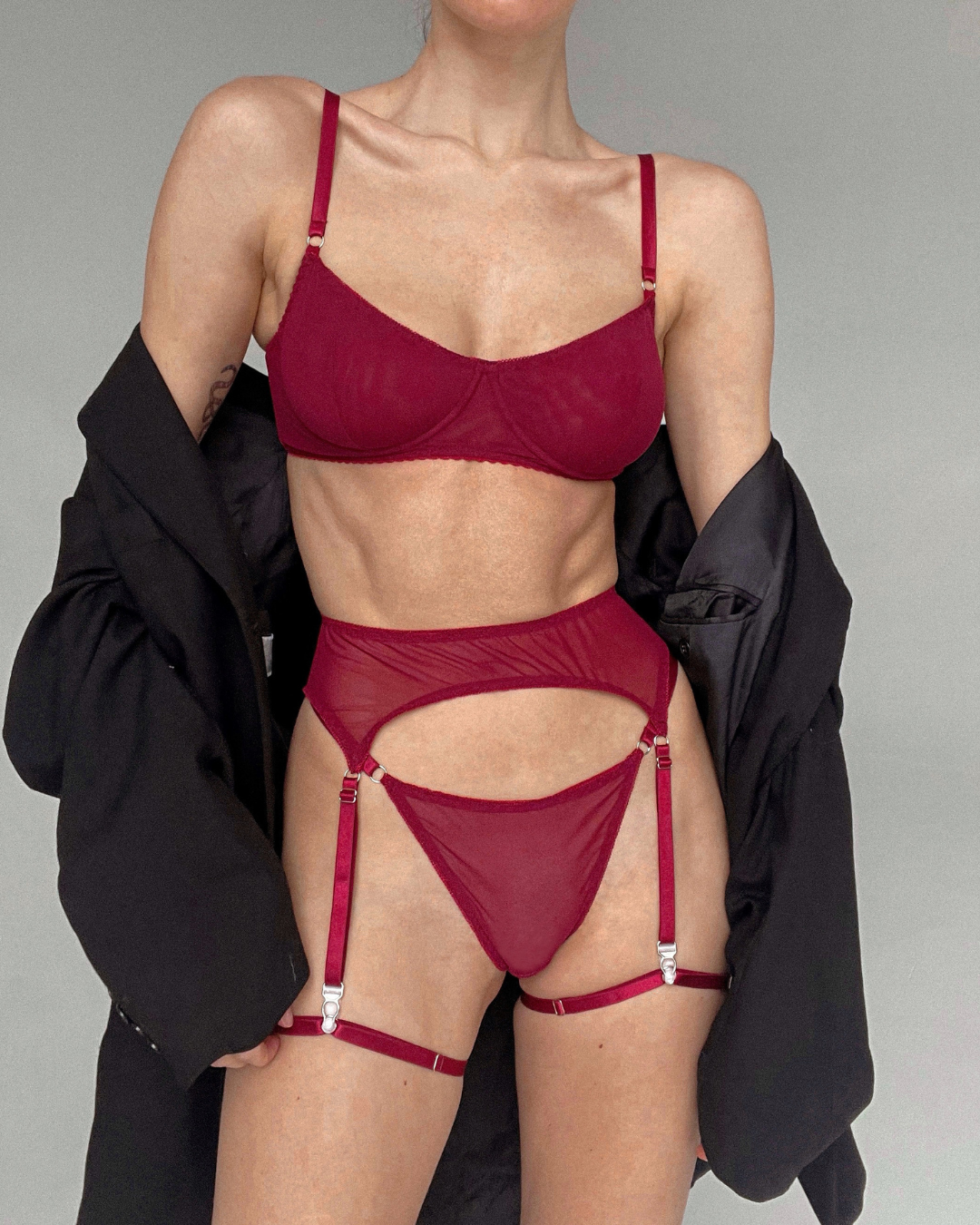 Model wearing Garters in Burgundy, featuring black elastic material and adjustable sizing